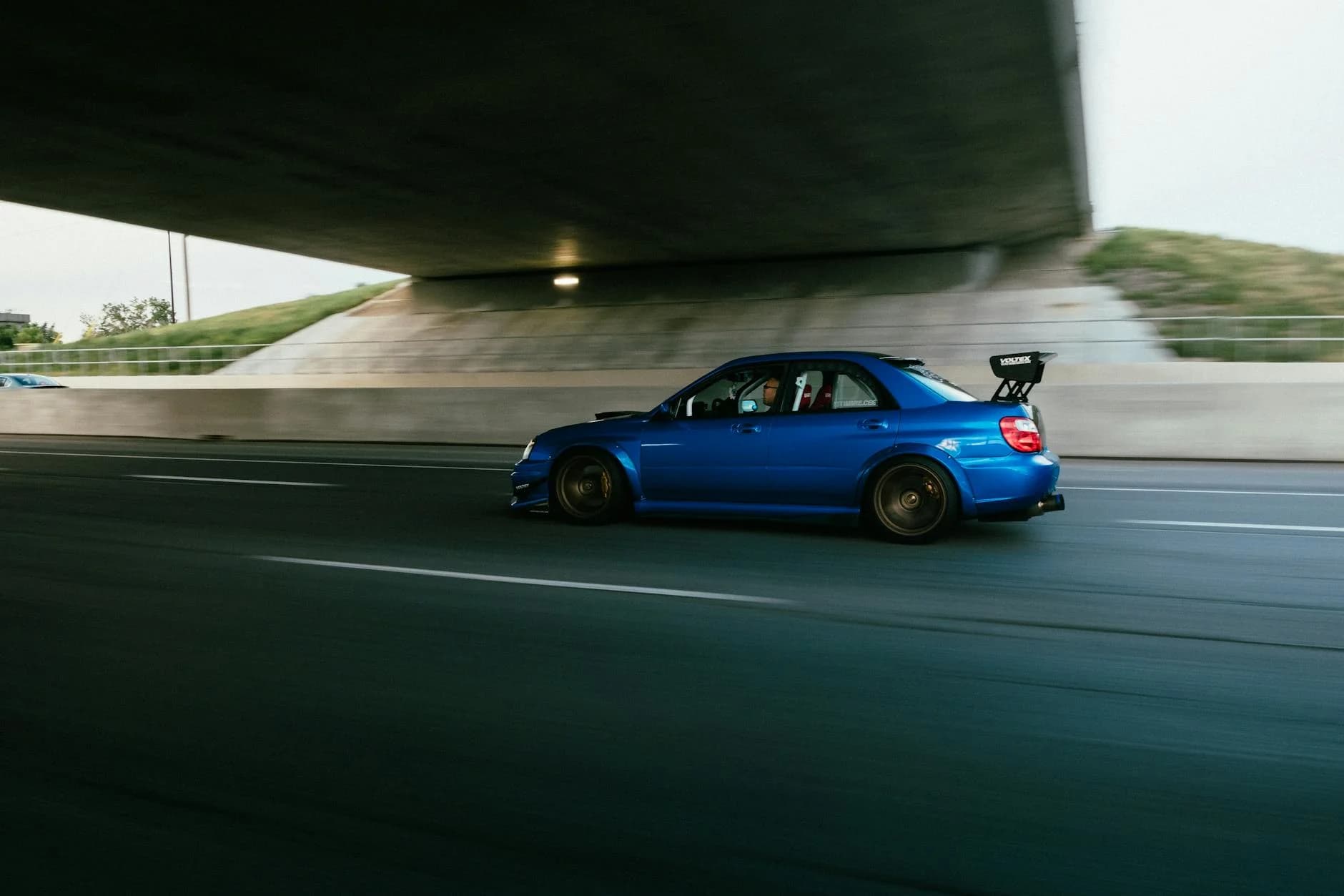 A Modified Blue Subaru Sti Speeds Under 2