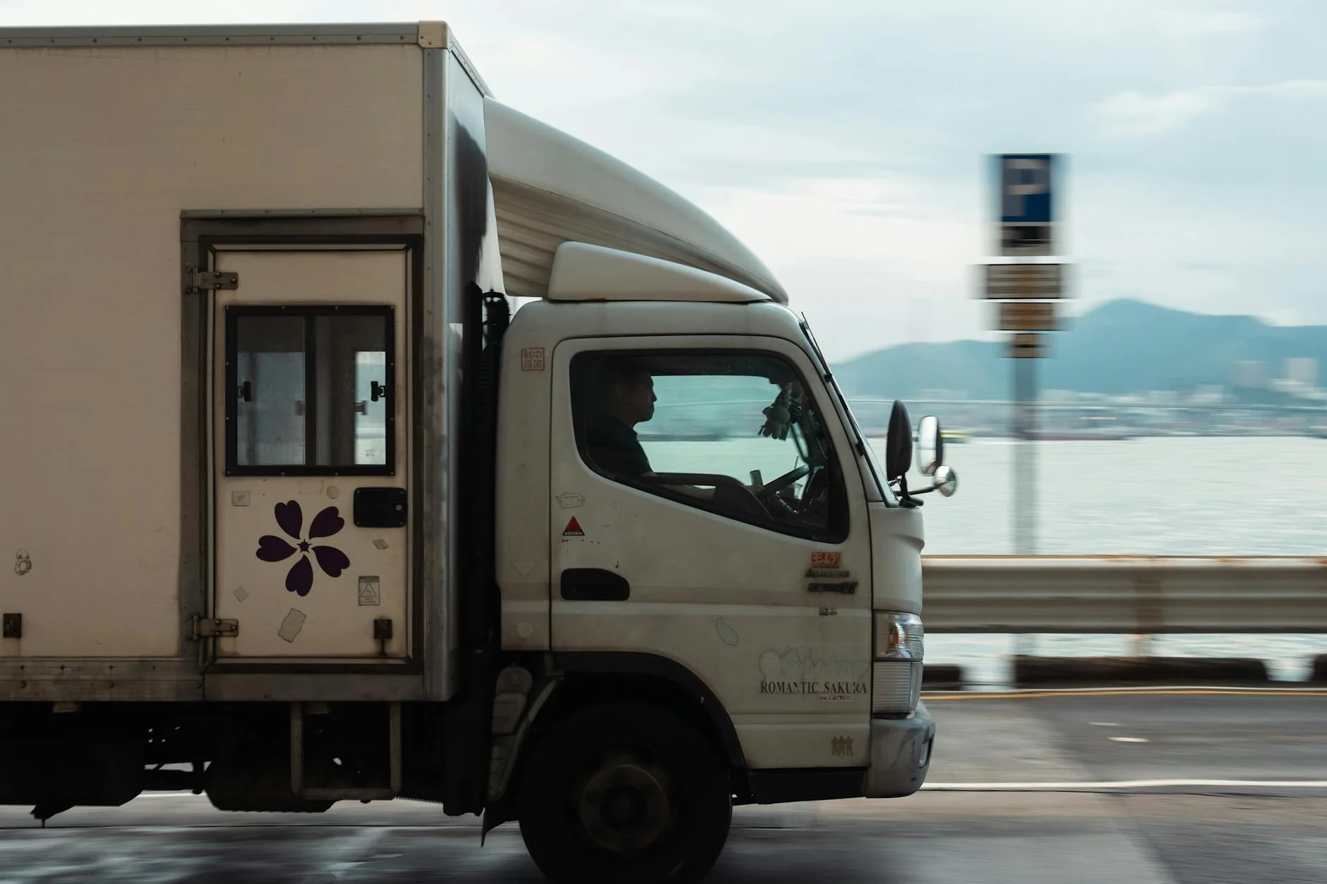 A Delivery Truck Driving Along A Coastal 1