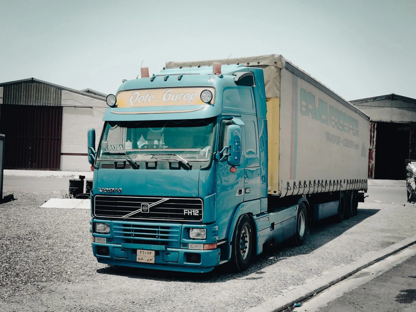 A Blue Volvo Truck Parked Outside A Ware 3