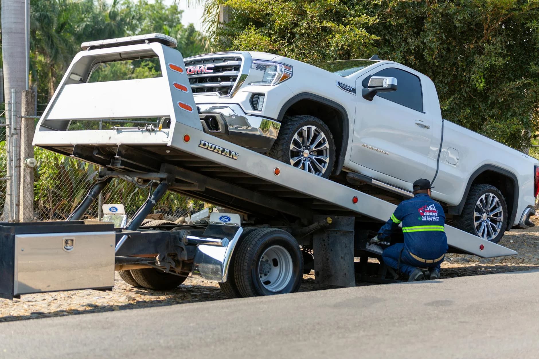 Tow Truck Operator Loading White Gmc Pic 2