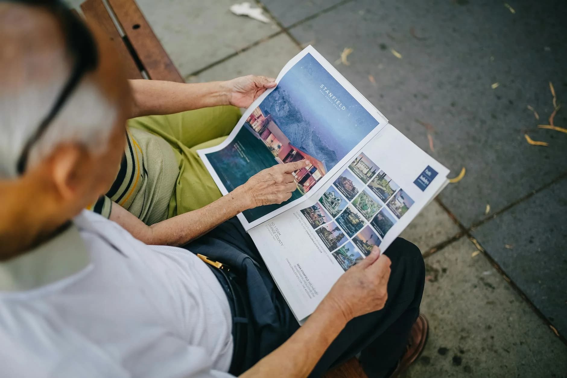 An Elderly Couple Sitting Outdoors On A 2