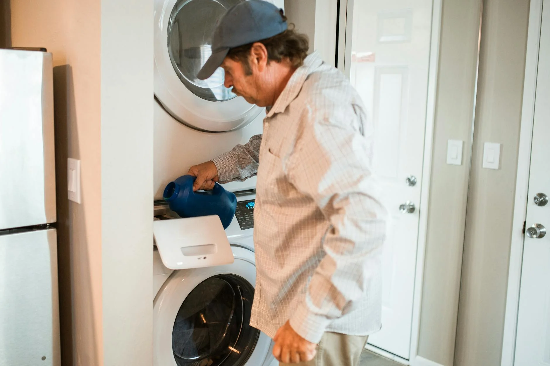 Man Pouring Liquid Detergent Into A Stac 3