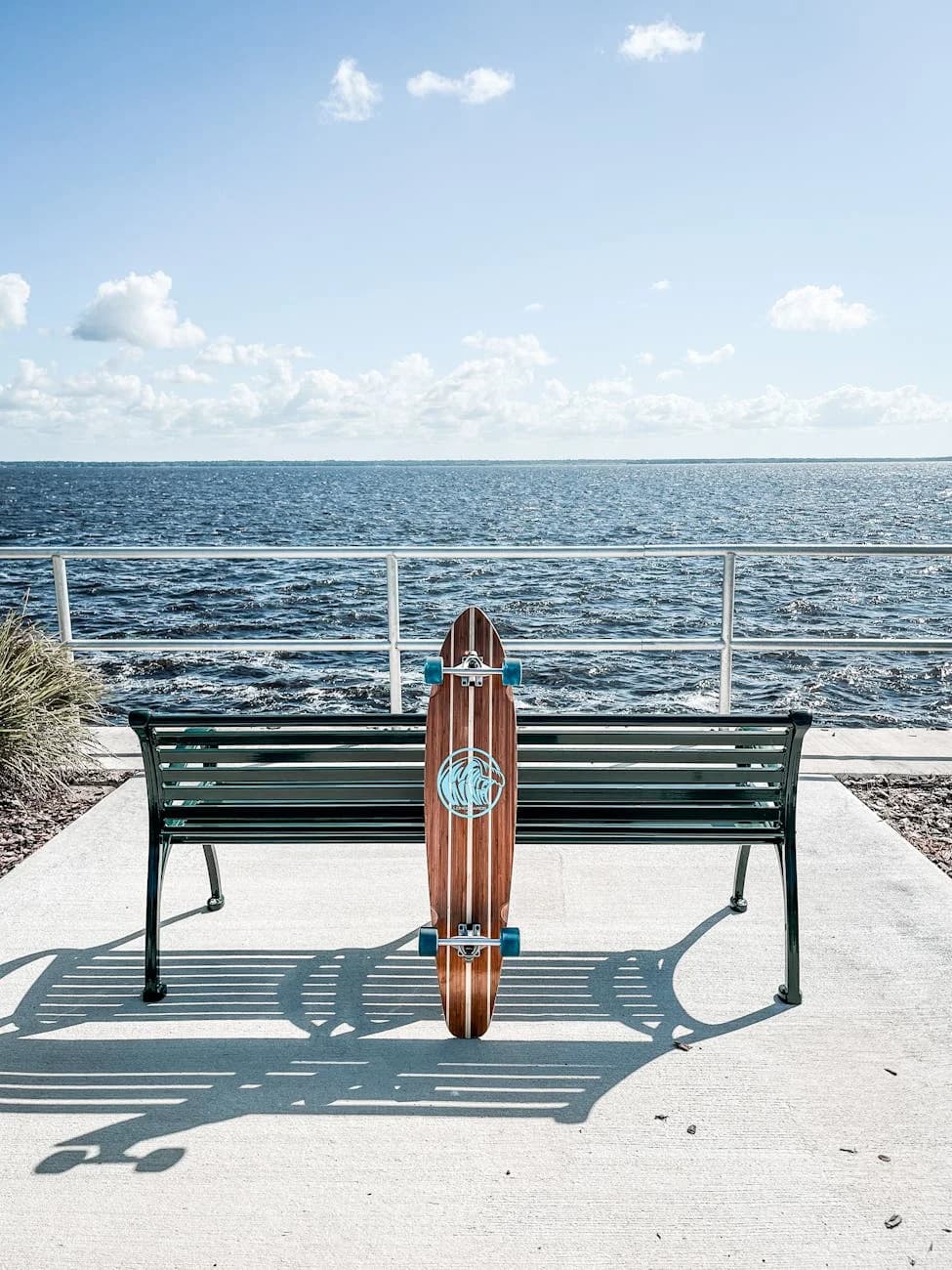 A Longboard Leans Against A Bench Overlo 1