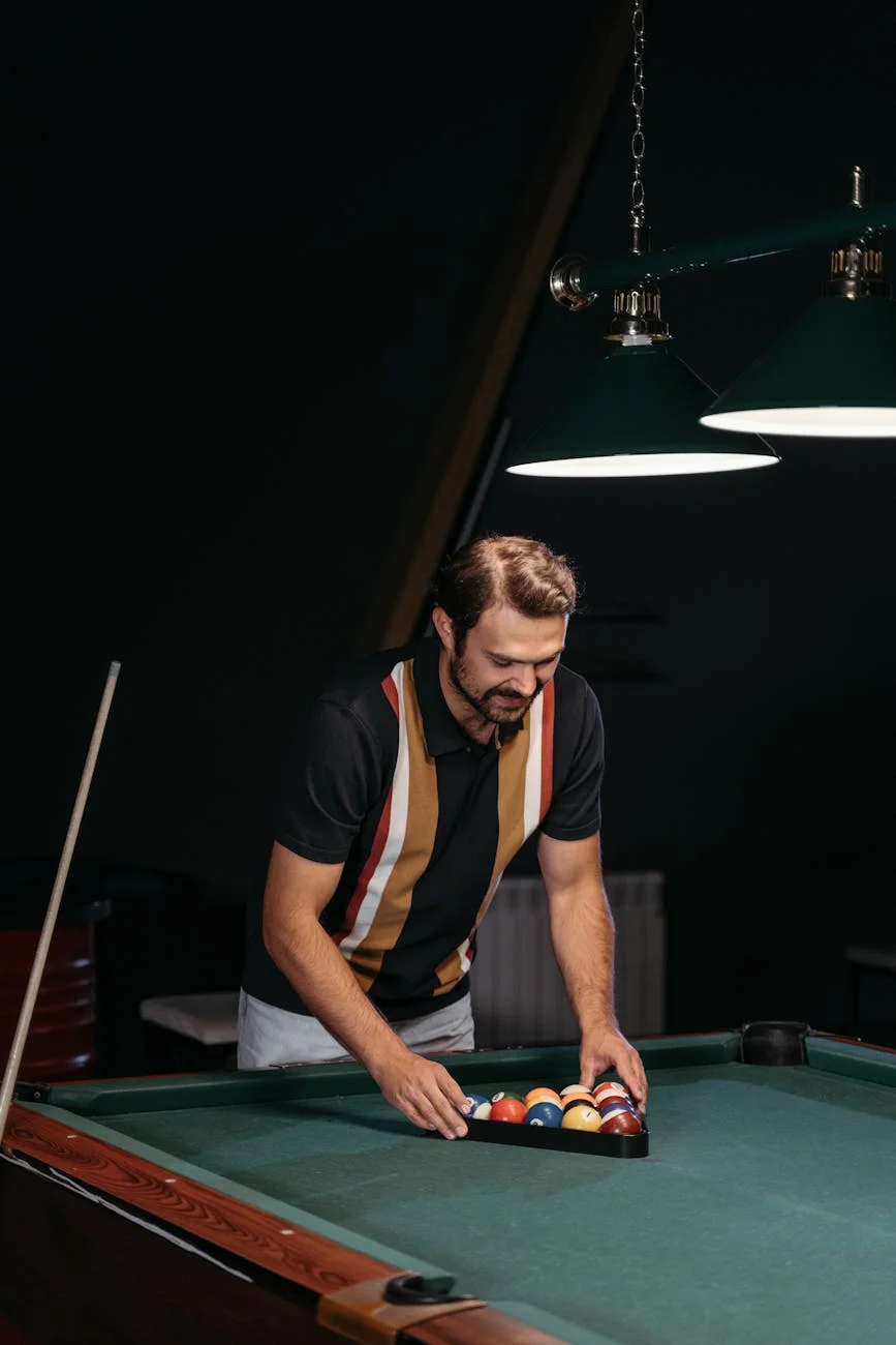 A Man Aligning Billiard Balls In A Rack 2