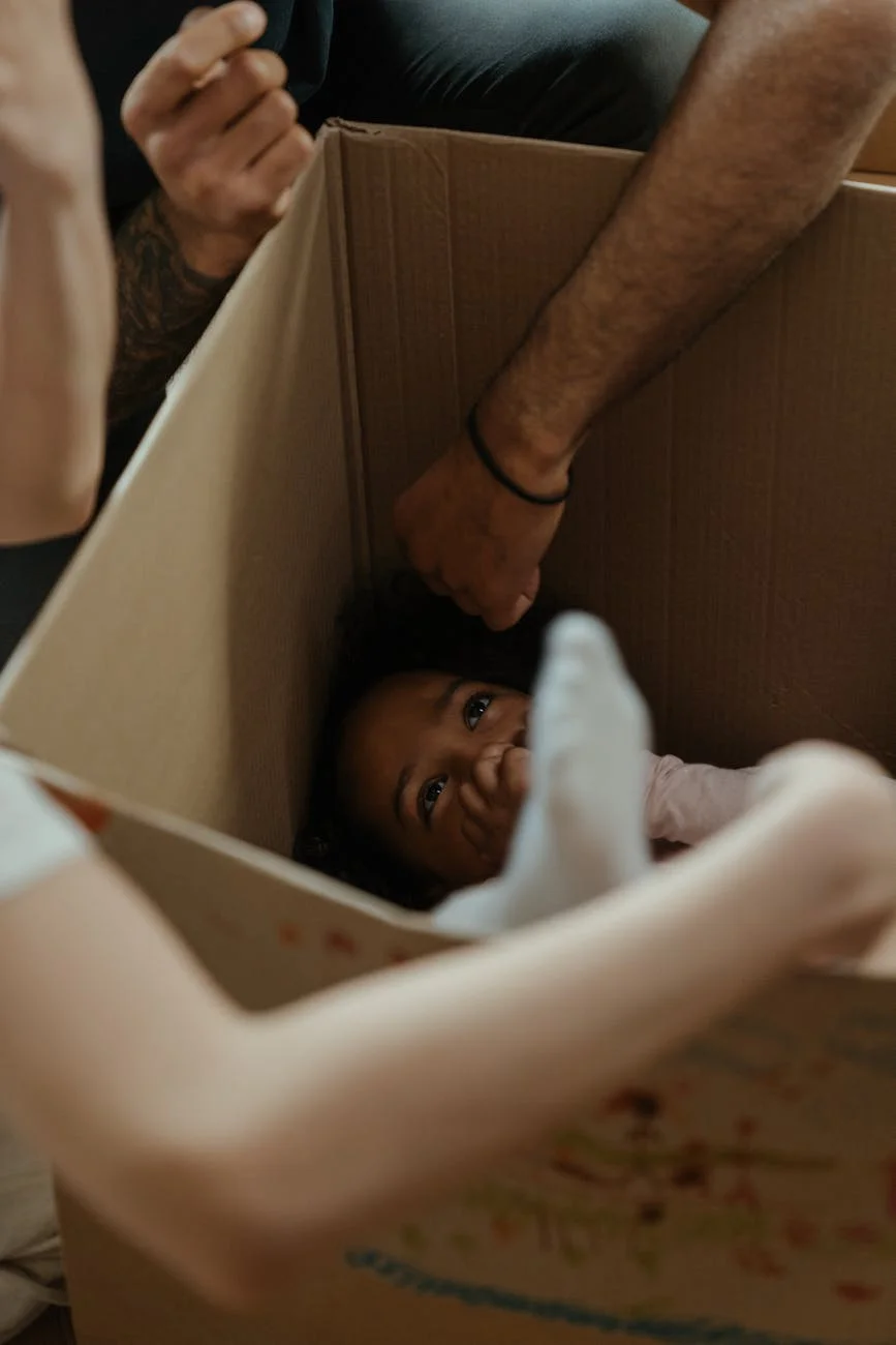 A Happy Child Plays Inside A Cardboard B 1