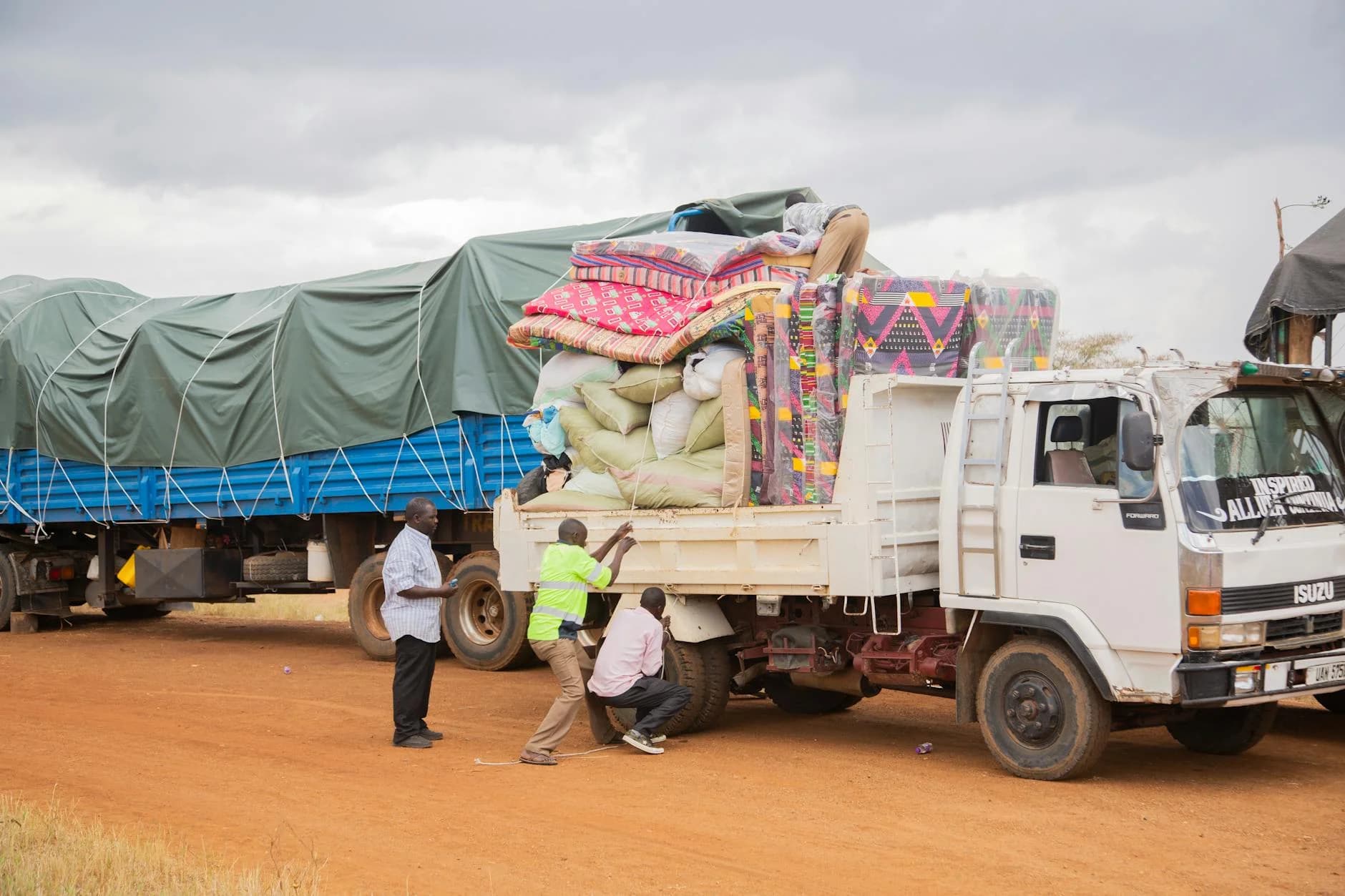 People Loading Supplies Onto A Truck In 2