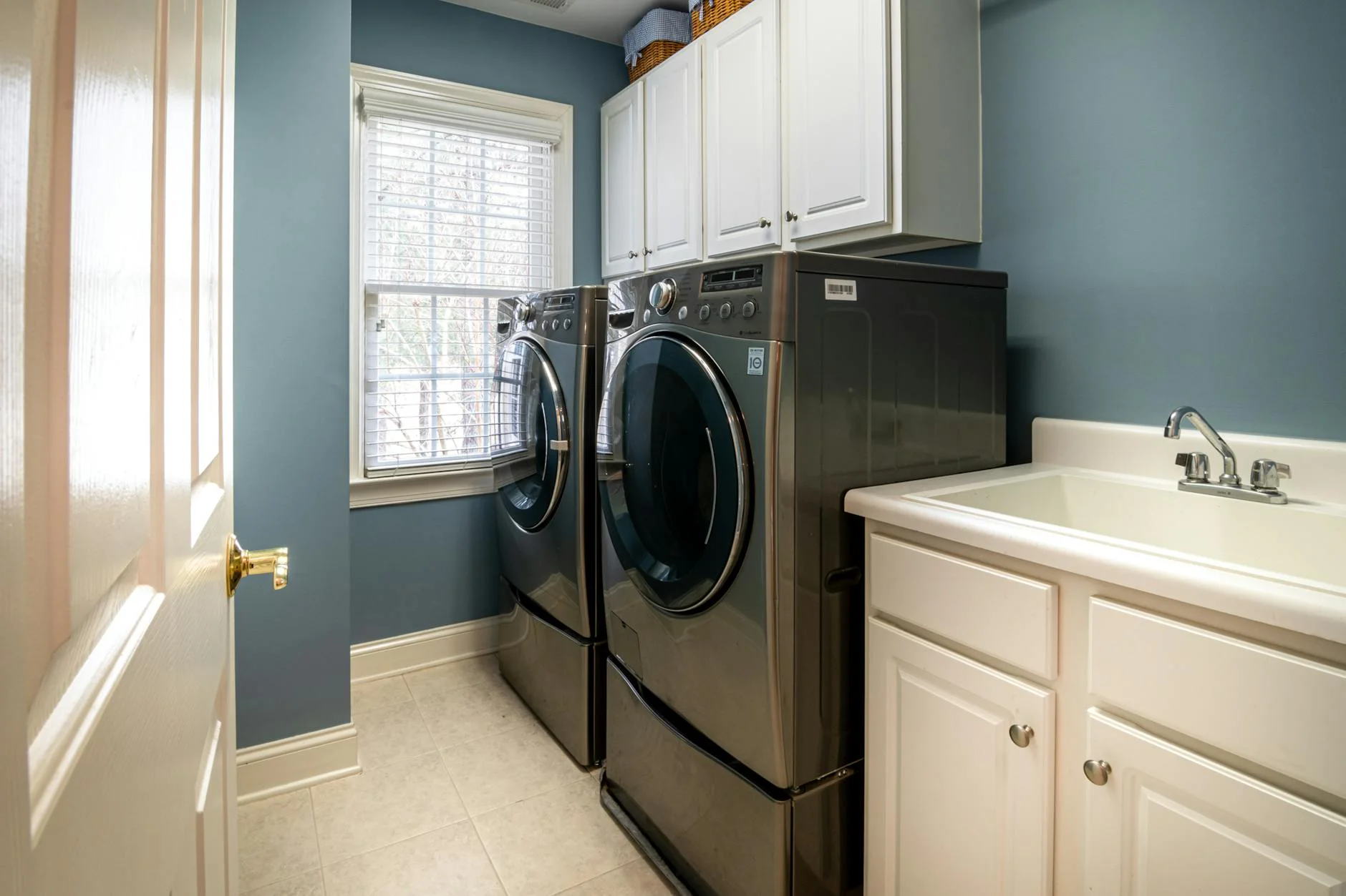 A Clean Organized Laundry Room Featuring 1