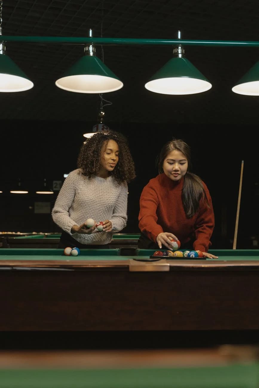 Two Young Women Play Billiards Indoors E 4