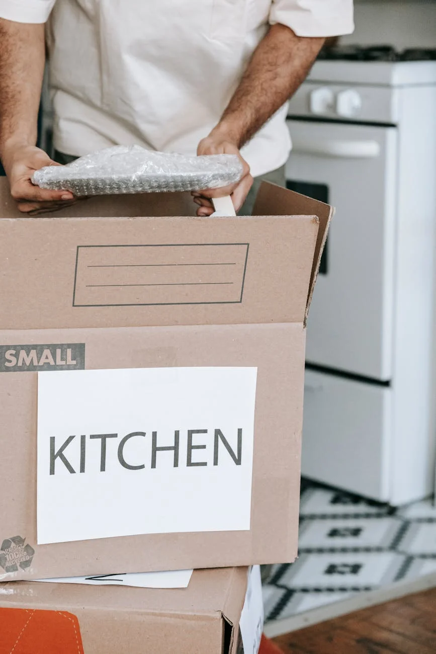 Man Packing Kitchenware Into Labeled Box 2