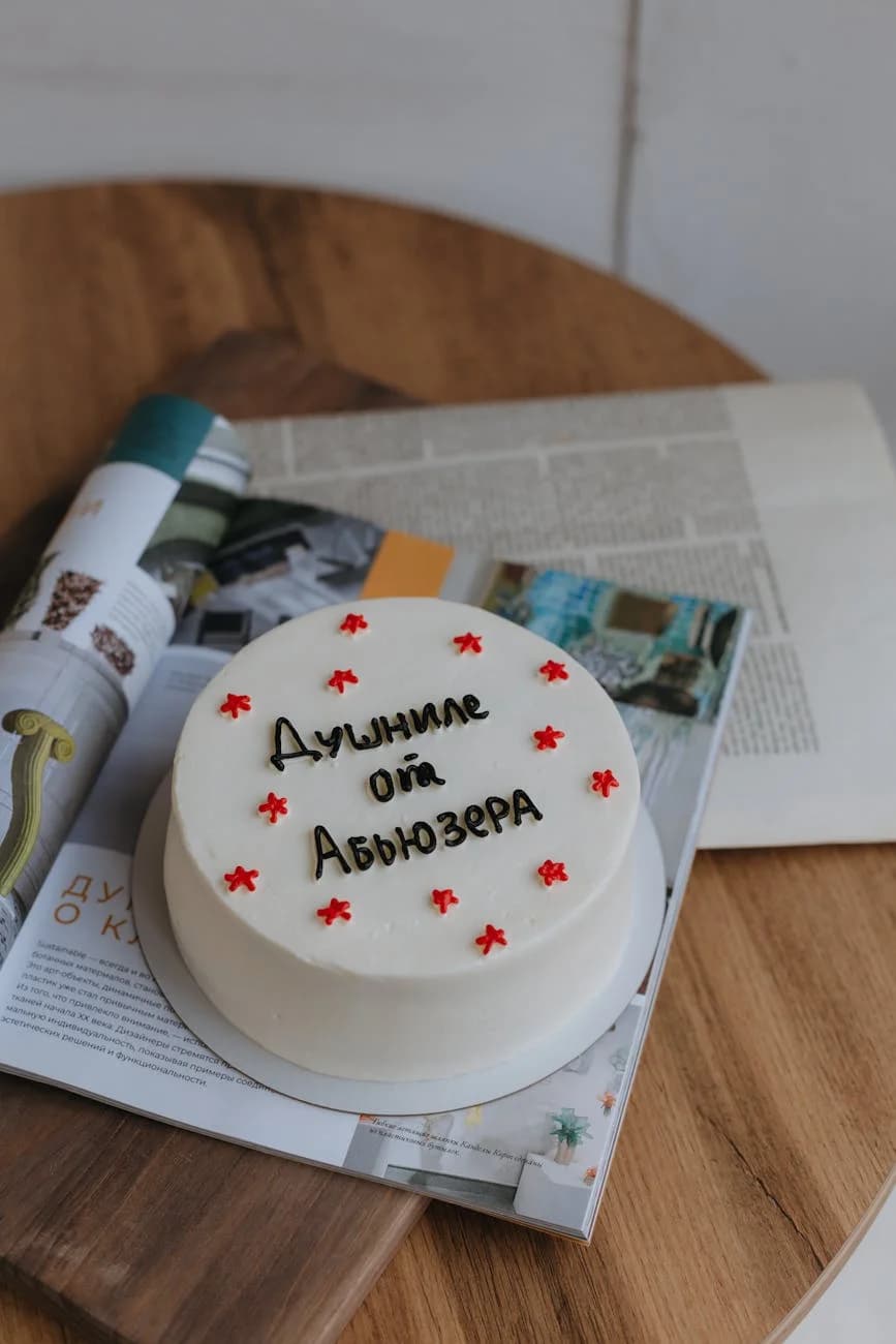 White Cake With Cyrillic Text Placed On 5