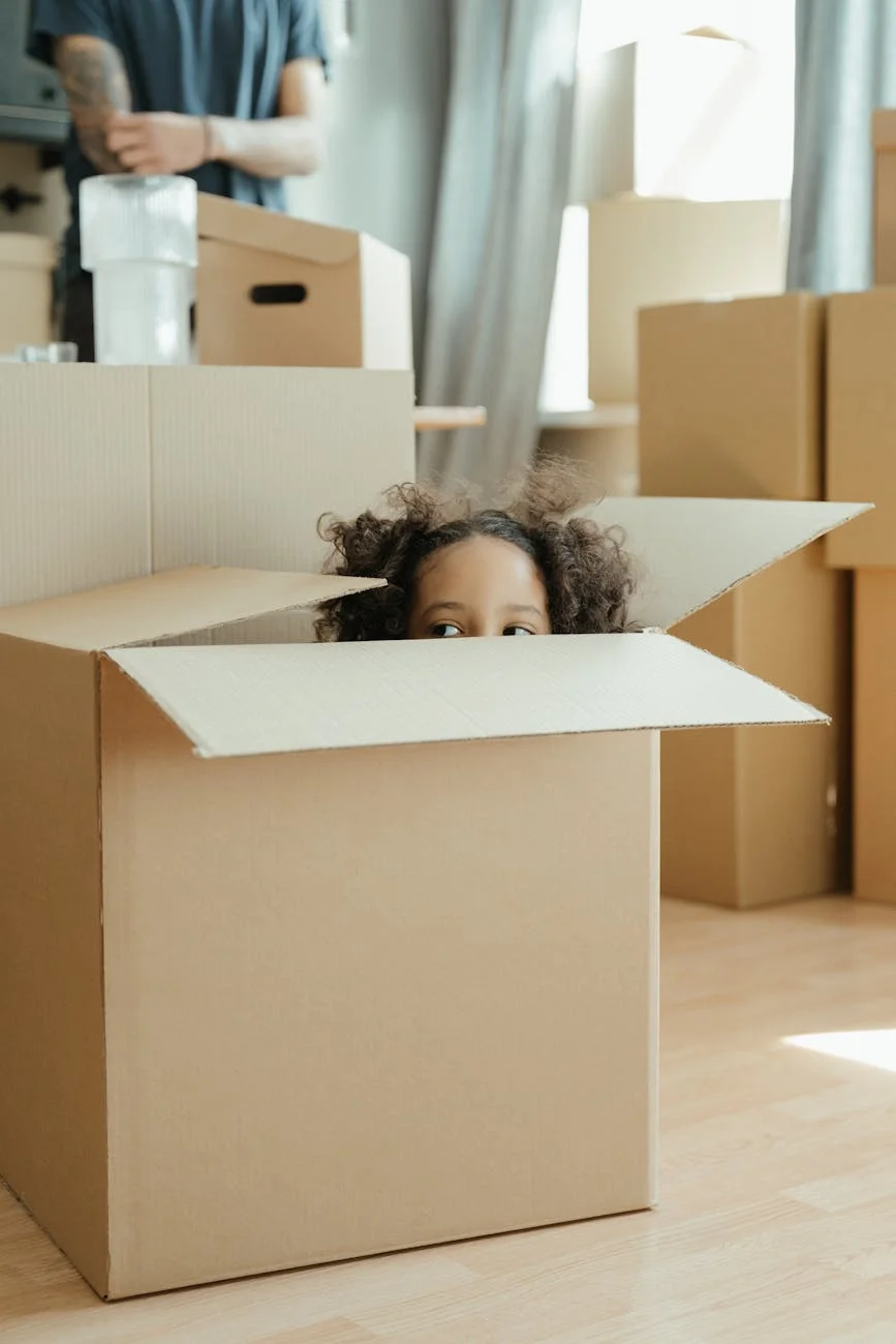 A Playful Child Peeks Out Of A Cardboard 1