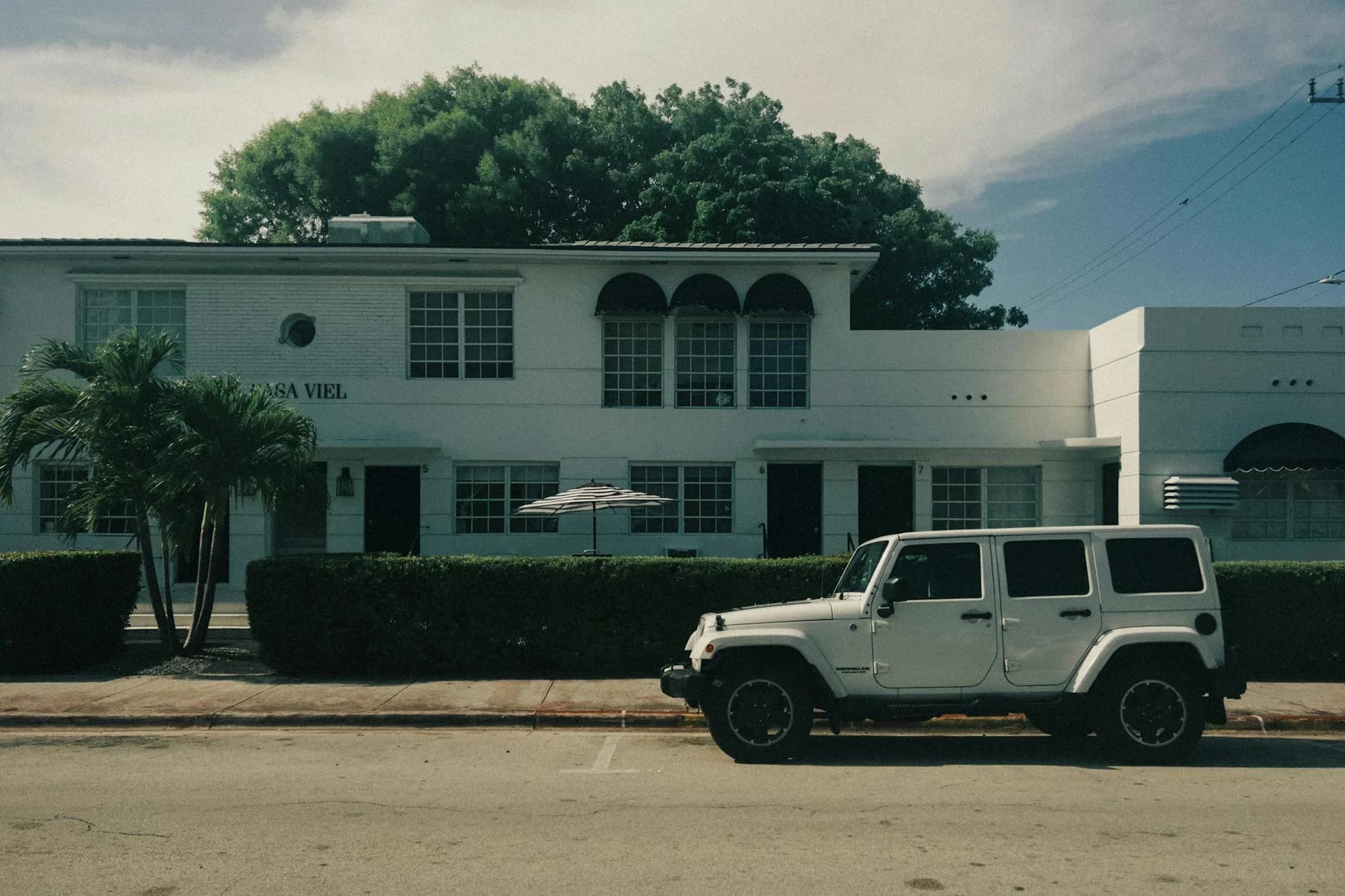 White Jeep Parked Outside Casa Viel An A 1