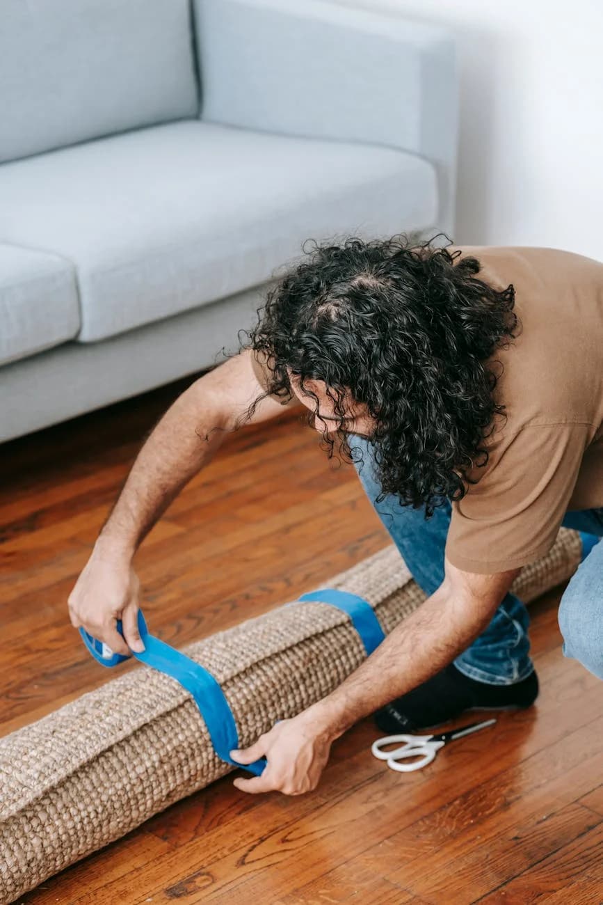 Man Securing A Rolled Carpet With Tape I 2