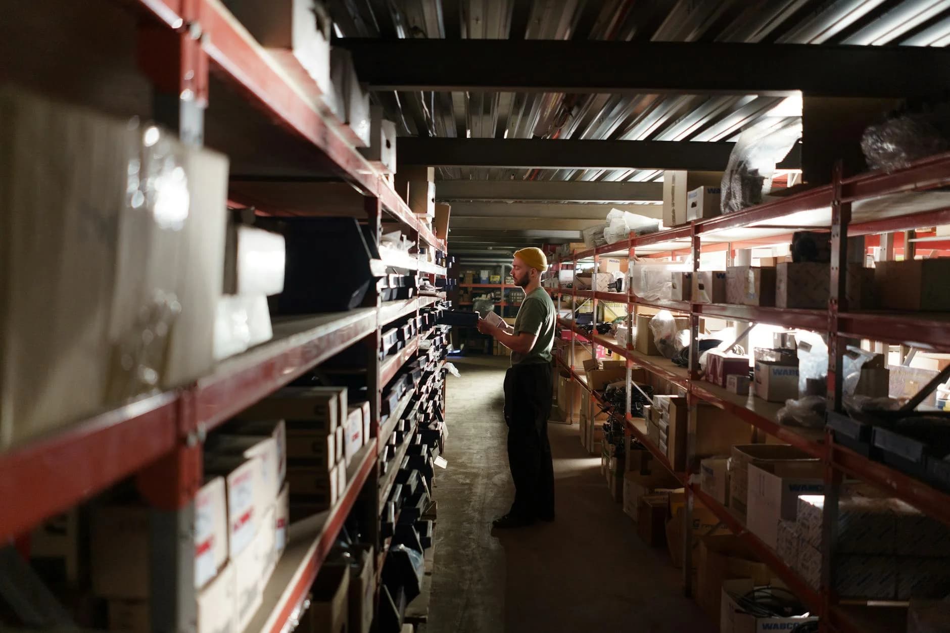 A Warehouse Worker Sorting Items On Shel 2