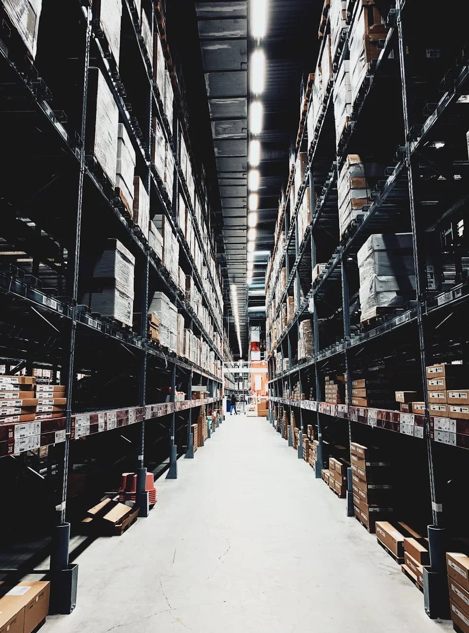 A Wide Aisle In A Large Warehouse Filled 5