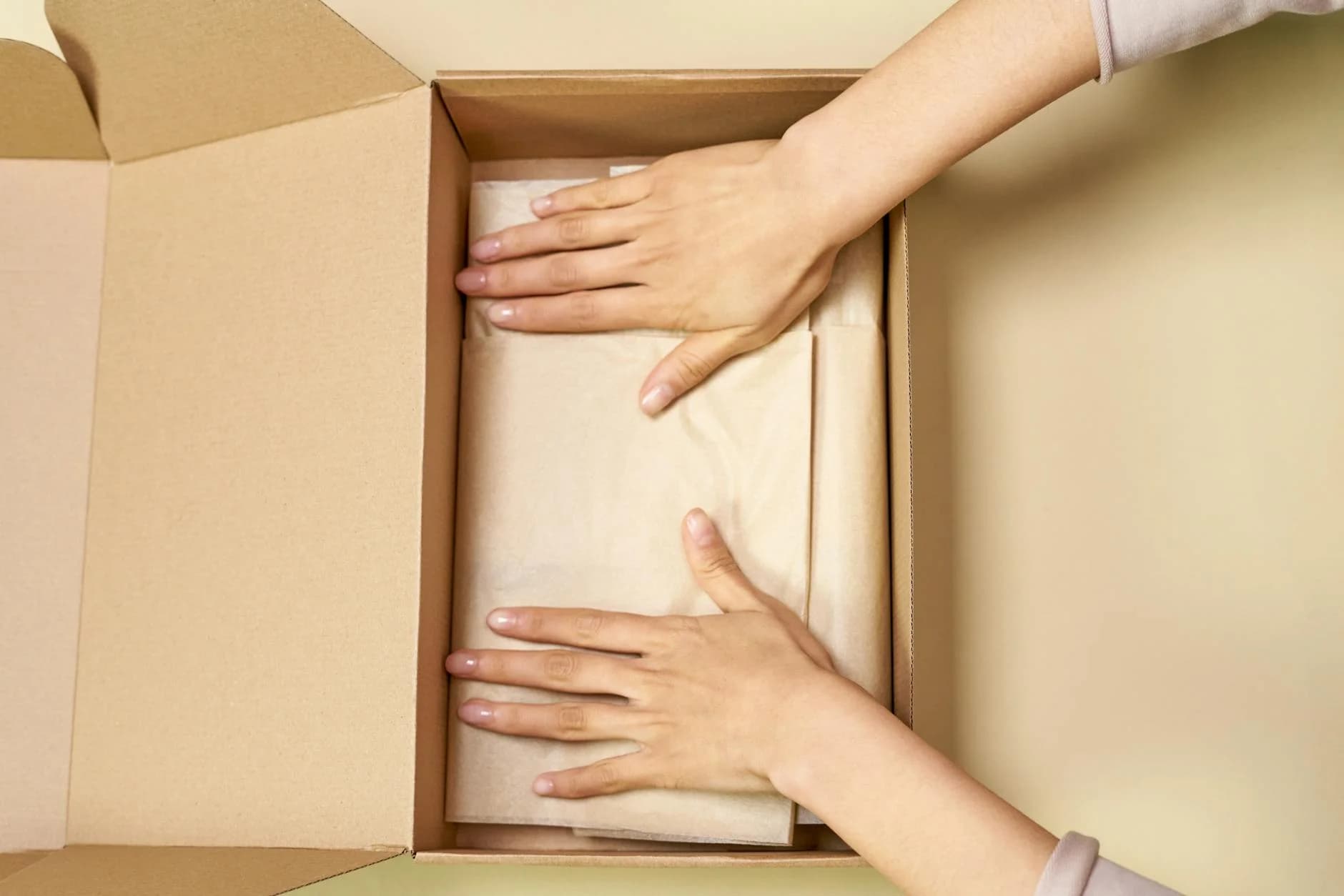 Close Up Of Hands Packing A Cardboard Bo 3