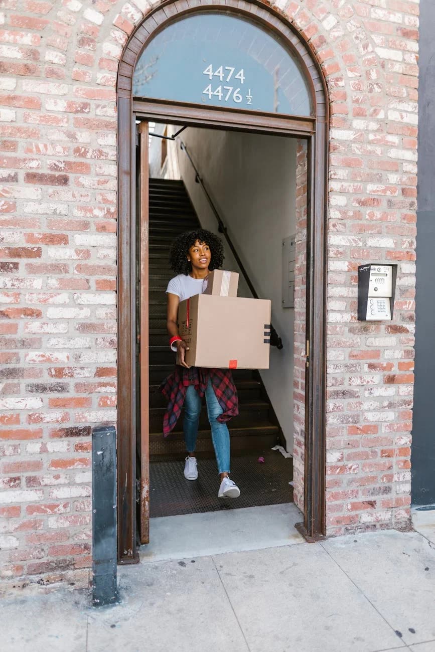 Young Woman Moving Boxes Out Of An Apart 4