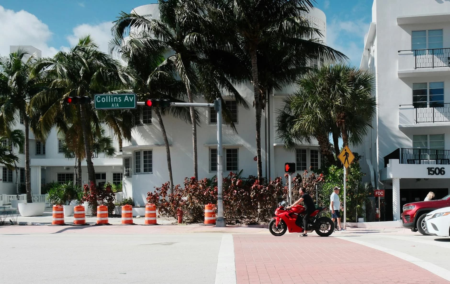 Motorcycle Passing Collins Avenue In Sun 1