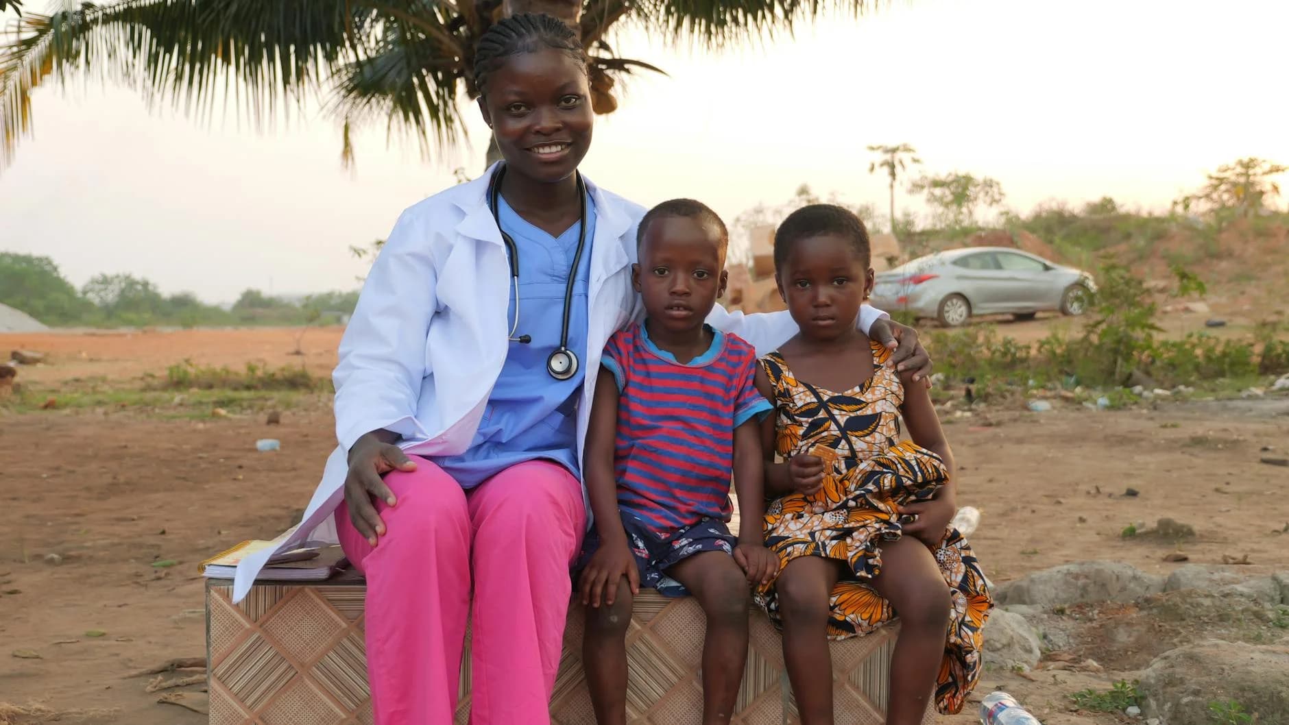 Female Healthcare Worker Smiles With Two 1