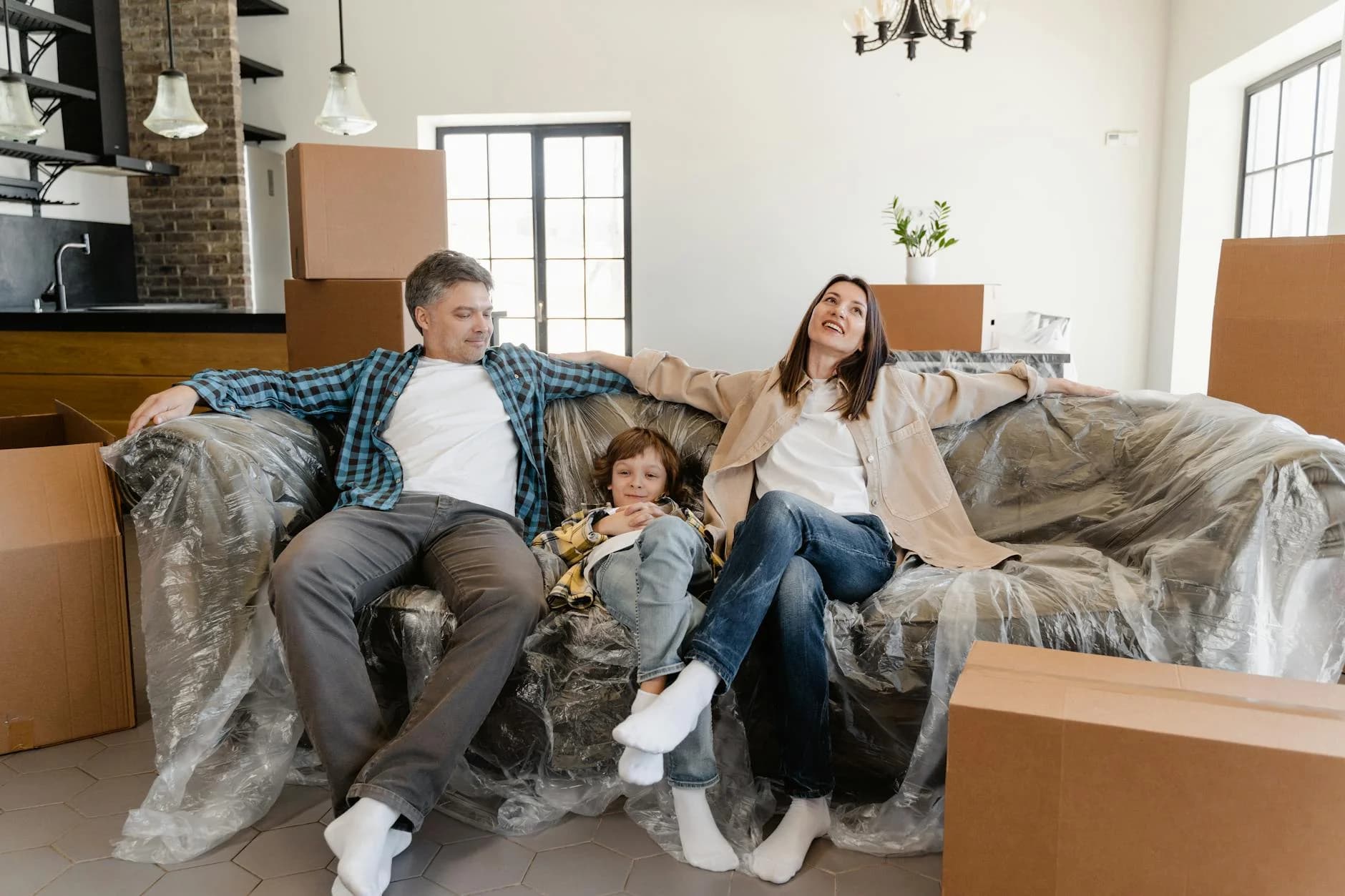 Smiling Family Sitting On A Covered Sofa 4