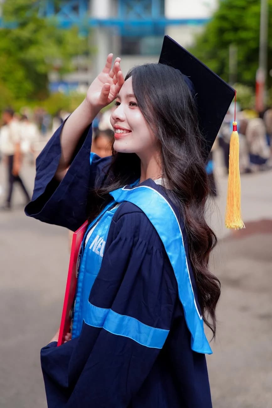 Smiling Young Woman In Graduation Gown A 4
