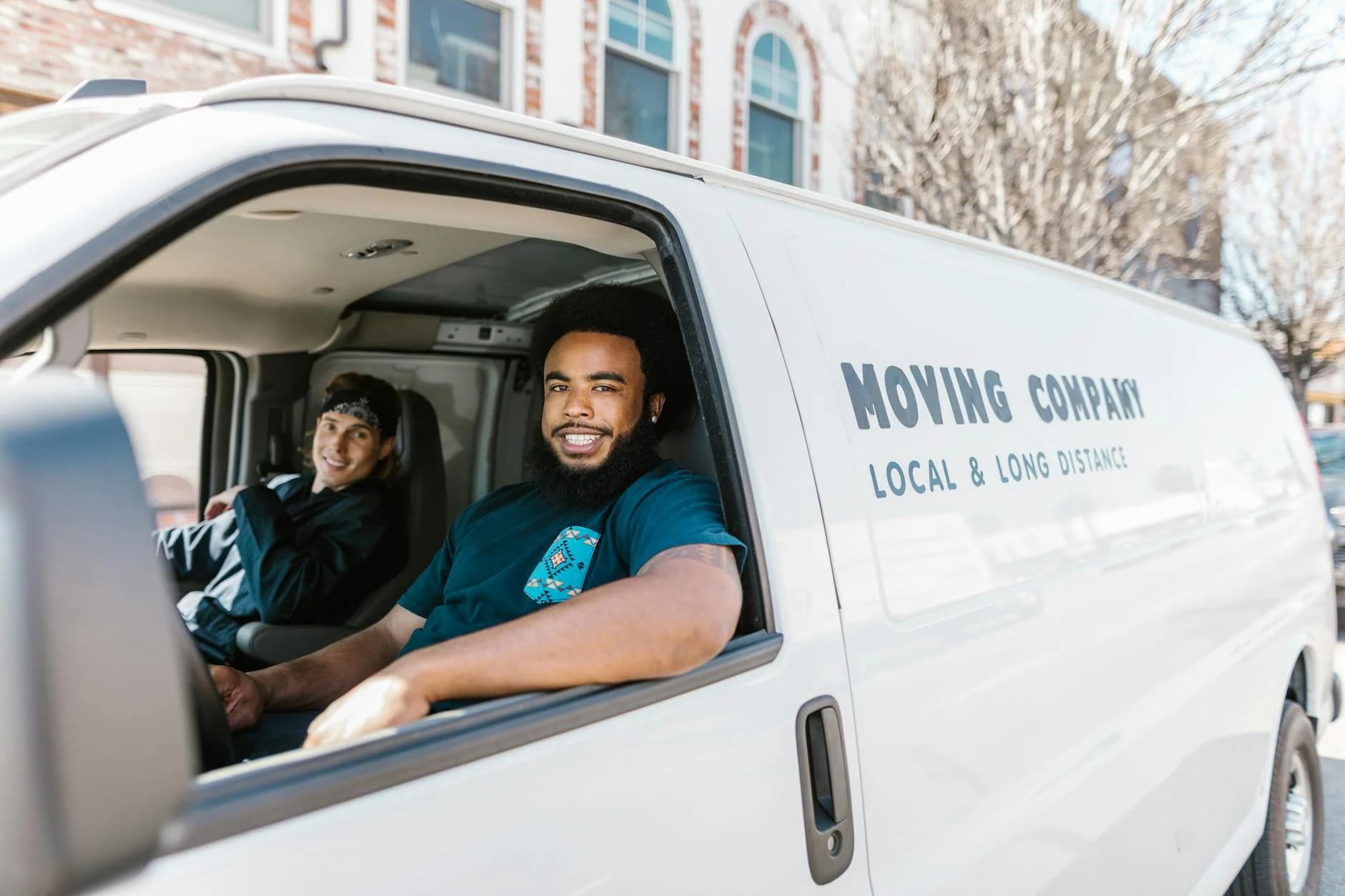 Two Movers Smiling From Their Moving Com 1