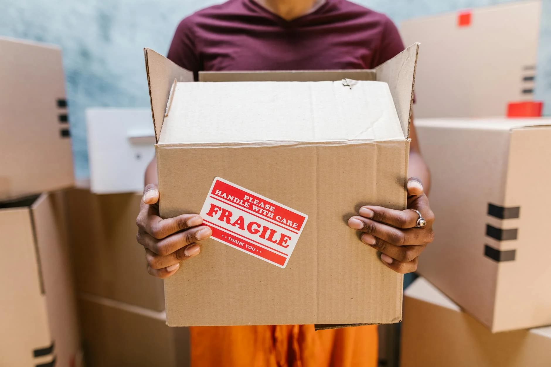 A Person Holding A Cardboard Box Labeled 5