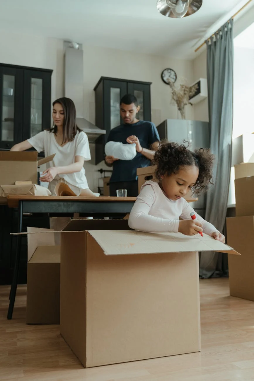 A Family Of Three Unpacking Boxes In The 2