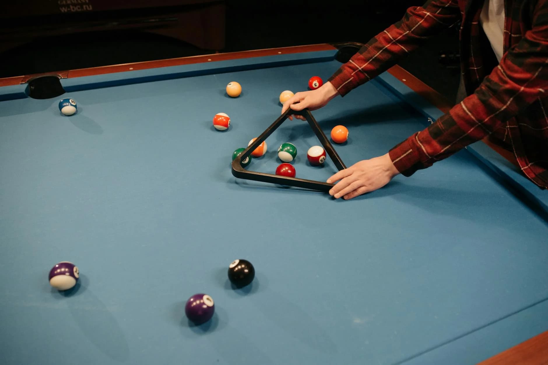 A Person Arranging Billiard Balls On A B 4